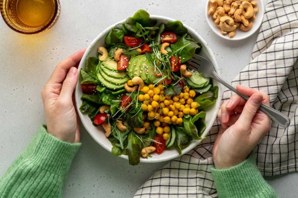 Vrouw eet salade met peulvruchten