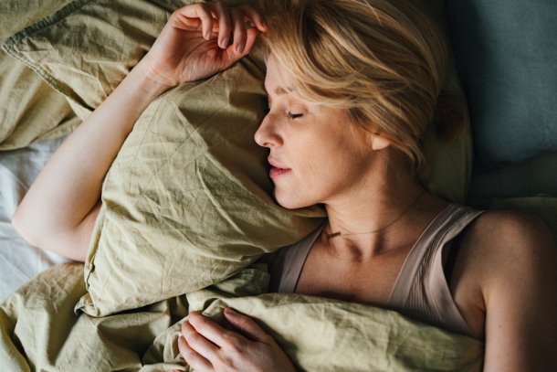 vrouw slaapt op haar zij in bed